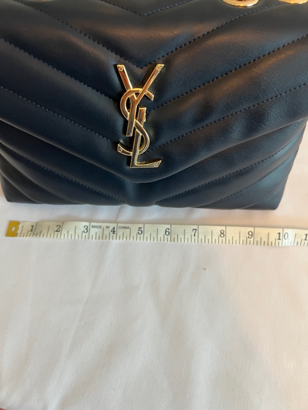 Yves Saint Laurent Navy Blue with gold tone chain and emblem. - Picture 9 of 11
